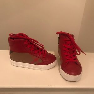 Toddler’s red Burberry hi top sneakers.